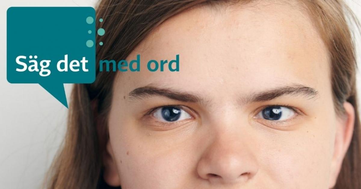 Ung dam med synnedsättning och brunt hår tittar mot kameran. Säg det med ord-pratbubbla i hörnet.